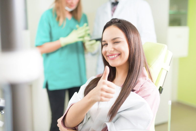 Patient smiling after getting a dental filling