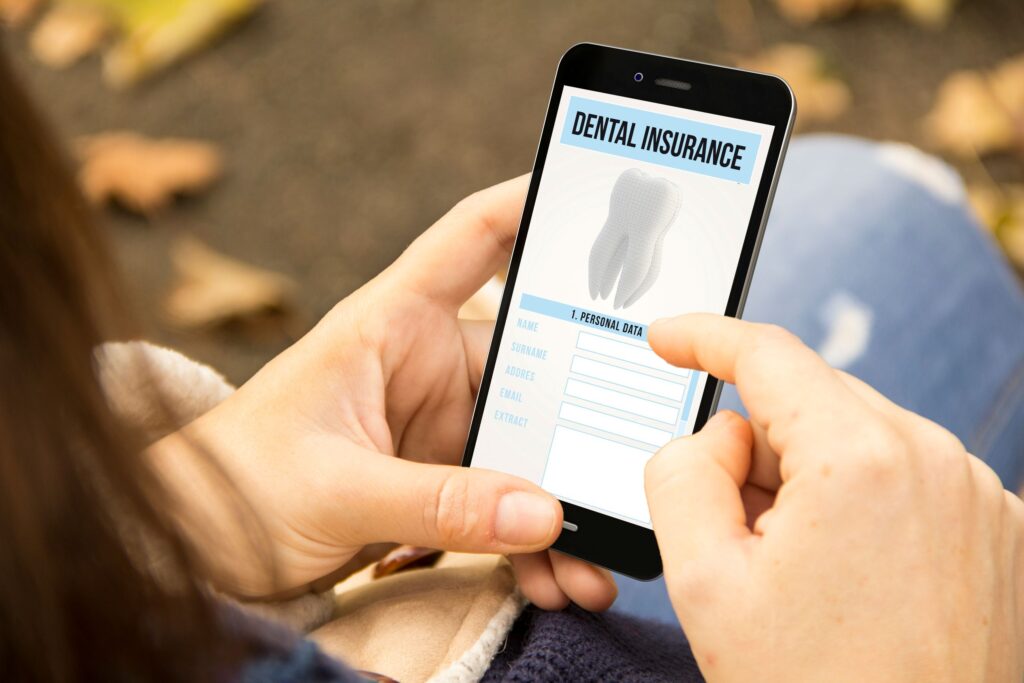 Someone scrolling dental insurance on their smartphone